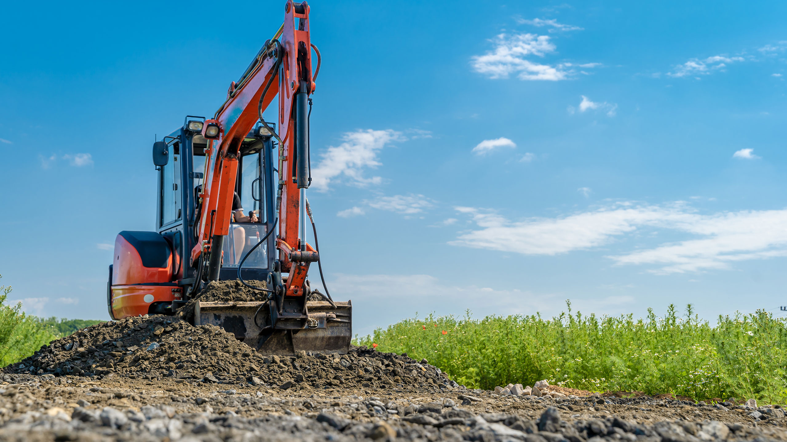 A contractor plant hire machine digging in the soil
